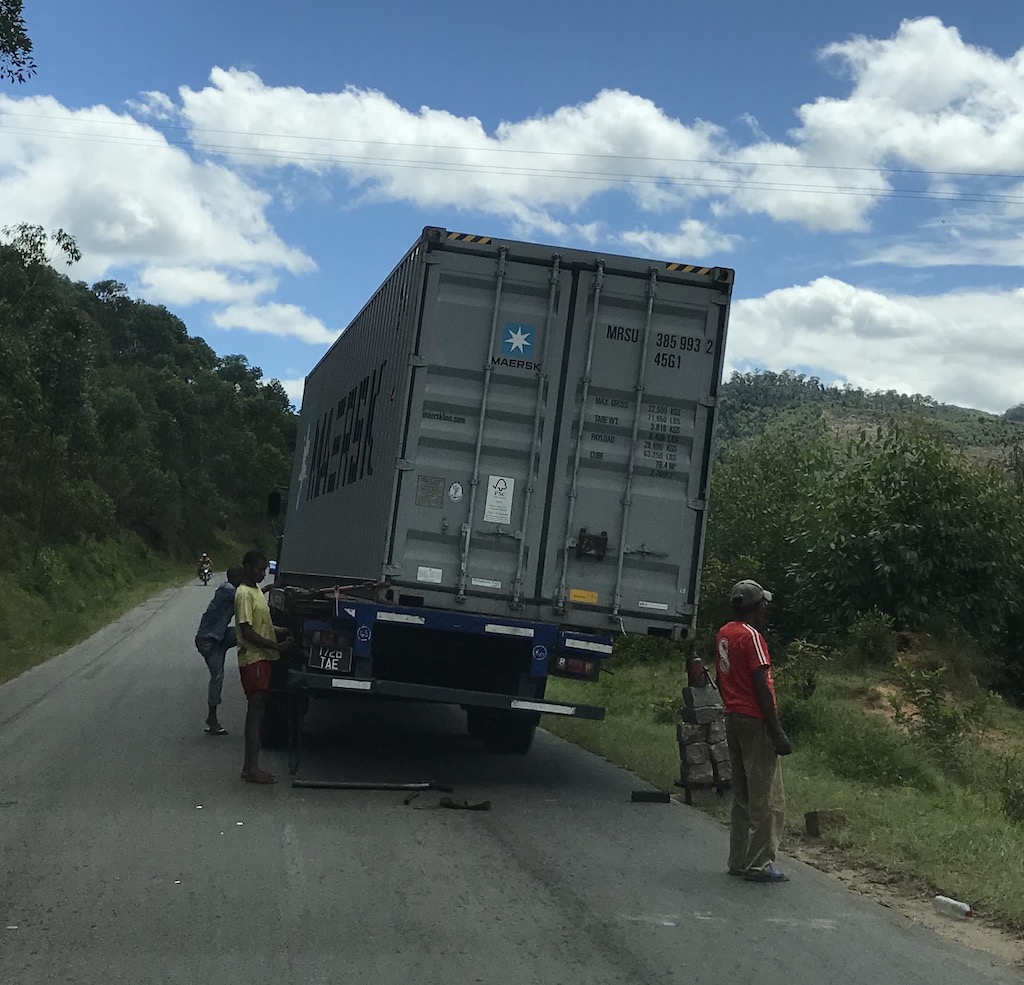 Truck with a dislodged container (note how they keep it from falling off)