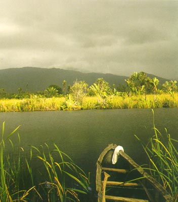 Dark clouds, sun, and a pirogue